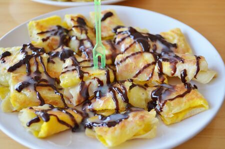 Roti banana topped with chocolateの写真素材