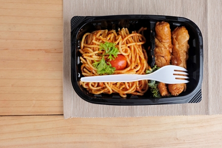 spaghetti tomato sauce with Sausage in Food box on a wooden tableの写真素材