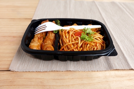 spaghetti tomato sauce with Sausage in Food box on a wooden tableの写真素材