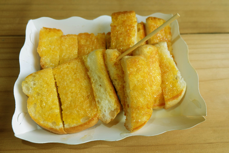 Toast Spread Margarine put Sweetened condensed milk on a plate of paperの写真素材