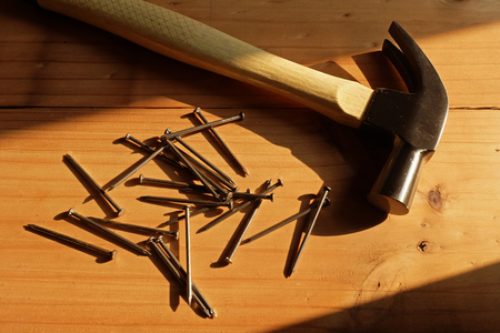 Hammer, nail and Wood with Warm lightの写真素材