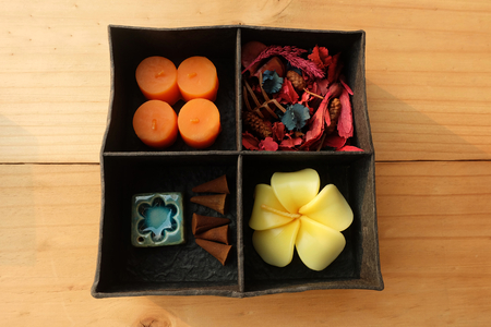 Spa Aroma therapy set in box, Candle Aroma, Roses Shaped Candles, incense sticks and dry flower on wooden floorの写真素材