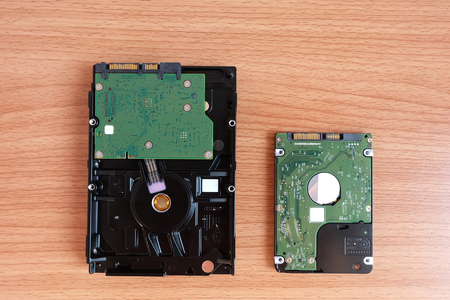 Internal Hard Disk Drive two sizes for Desktop and Laptop computer on wooden floorの写真素材