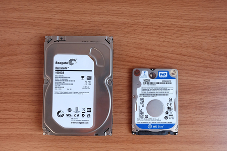 Bangkok, Thailand - March 17, 2018 Seagate 1TB. and WD 500GB. HDD SATAIII Internal Hard Disk Drive two sizes for Desktop and Laptop computer isolated on wooden floorのeditorial素材