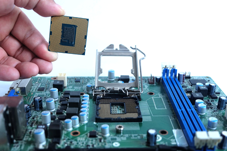 Close up installing cpu and motherboard, parts computer pc,on white backgroundの写真素材