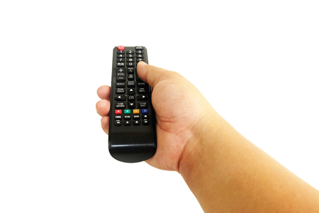 Hand is pressing the remote control TV isolated on white backgroundの写真素材