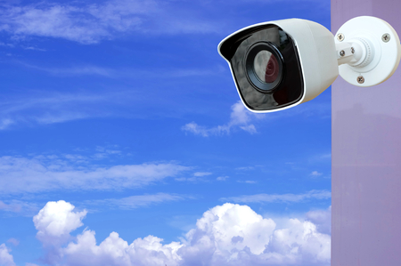CCTV Camera of security on blue sky and clouds background