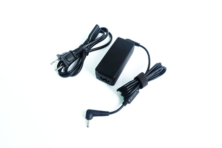 Adapter ac/dc power charger with wire of laptop computer isolated on white backgroundの写真素材