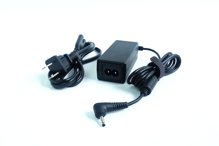 Adapter ac/dc power charger with wire of laptop computer isolated on white backgroundの写真素材