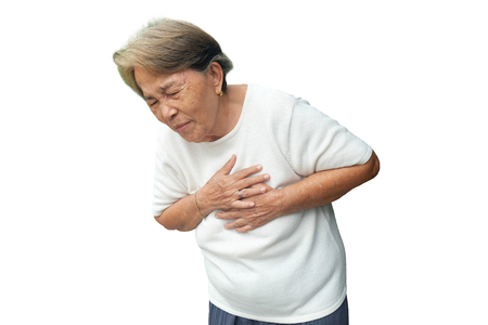 Elderly asian woman with chest pain with heart attack isolated on white backgroundの写真素材