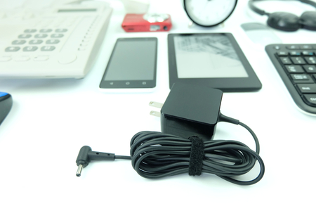Close up Adapter acdc power charger of laptop computer and blurred Used modern Electronic gadgets for daily use isolated on white backgroundの写真素材