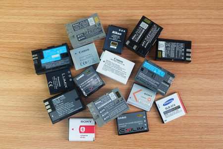 BANGKOK, THAILAND - September 14, 2018 : Used battery for compact camera and dslr in many brands on wooden backgroundのeditorial素材