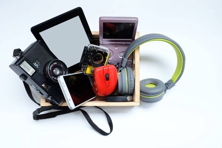 Many used modern Electronic gadgets for daily use in wooden cases on a white background, Reuse and...