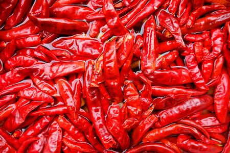 Red dried chili soaked in water, abstract background, Hot and spicy concept.