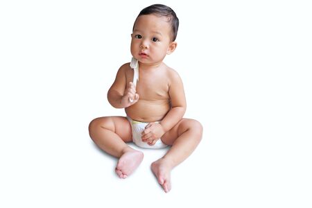 Cute little asian boy is wearing a diaper and playing on white backgroundの写真素材