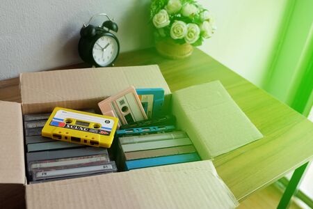 Old audio cassette tape in the old paper box on the deskの写真素材