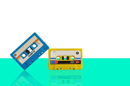Old colorful cassette audio tape on pastel color background, and leave blank space above for text inputの写真素材