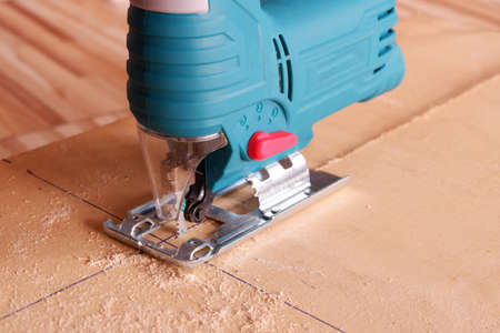 Electric jig saw machine cutting sheet woodの写真素材