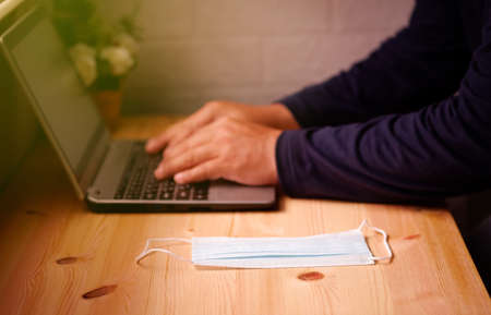 Business men working from home with Surgical mask or hygienic mask on laptop computer. Protection factors for covid-19, corona virus, pm2.5の写真素材