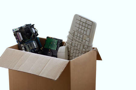 Old hard disk dive and motherboards and used keyboard with mouse old computer hardware accessories in paper boxes isolated on white, Obsolete equipment is electronic waste Reuse and Recycle concept.の写真素材