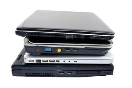 Broken or damaged used computer laptop stack isolated on white backgroundの写真素材