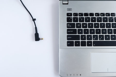 Adapter power cord charger of laptop computer on white background. Topviewの写真素材