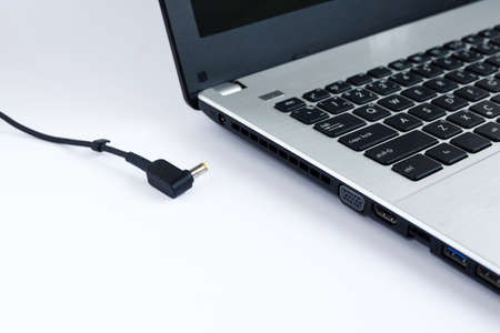 Adapter power cord charger of laptop computer on white backgroundの写真素材