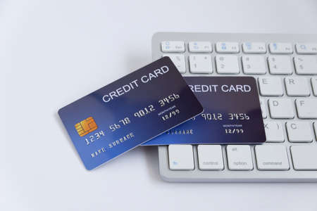 Credit card on computer keyboard on white desk. Concept of Online shopping and payment.の写真素材