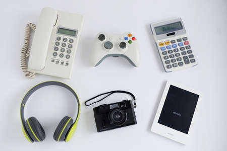Landline Phone with Joystick controller and Calculator and Film camera, other obsolete electronic gadgets on white background, Top view.の写真素材