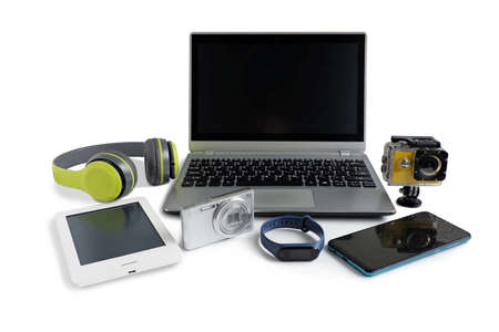 Laptop computer with smartphone and camera and ebook reader and other obsolete electronic gadgets on white background, Reuse and Recycle conceptの写真素材