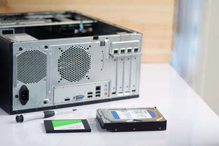 Hard drive and ssd with a screwdriver upgrade and repair desktop computer internal parts, selective focusの写真素材