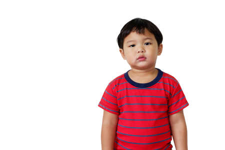 Cute Asian boy wearing bright red striped t-shirt standing on white background. With copy space for text.の写真素材