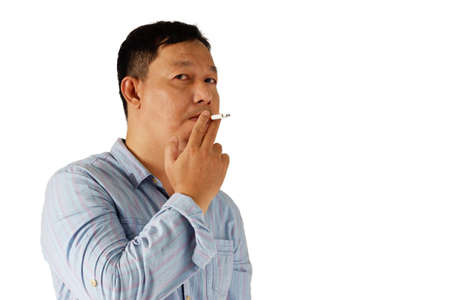 Asian man standing with smoking cigarette isolated on white backgroundの写真素材