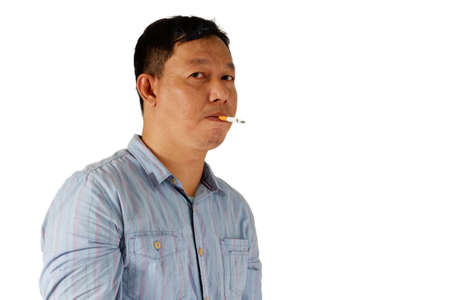 Asian man standing with smoking cigarette isolated on white backgroundの写真素材