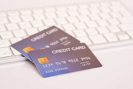 Credit card on computer keyboard on white desk. Concept of Online shopping and payment.の写真素材