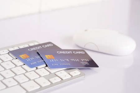 Credit card on computer keyboard on white desk. Concept of Online shopping and payment.の写真素材
