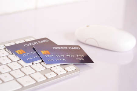 Credit card on computer keyboard on white desk. Concept of Online shopping and payment.の写真素材