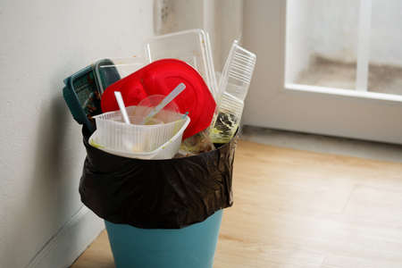 Disposable plastic food containers in the trash, Household plastic waste problem, recycleの写真素材
