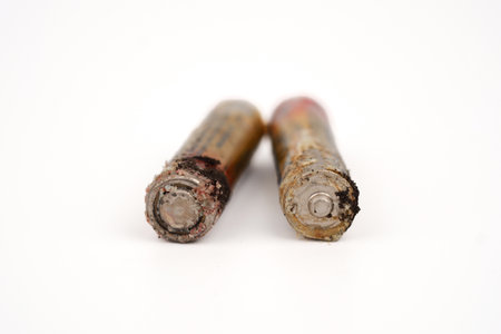 Damaged and corroded batteries isolated on white background.の写真素材