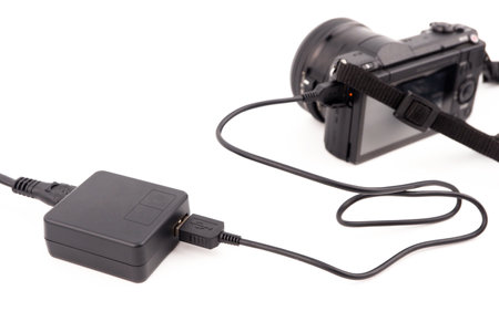 Plug in an adapter cable to charge the camera, a usb charger cable for various electronic devices.の写真素材