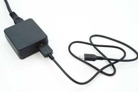 Plug in an adapter cable to charge the camera, a usb charger cable for various electronic devices.の写真素材