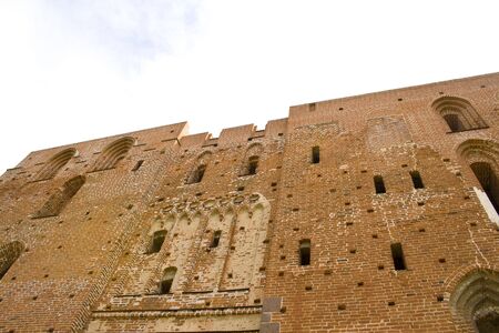 Ruined medieval castle in Latvia on a background of the blue skyの写真素材