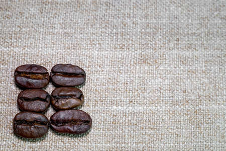 black coffee grains laid in the form of a frame on a coarse linen cloth, removed from aboveの写真素材