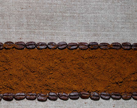 black coffee grains and ground coffee laid in the form of a frame on a coarse linen cloth, removed from aboveの写真素材