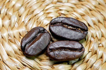 black coffee grains scattered on a braided authentic background, photographed from above close-upの写真素材