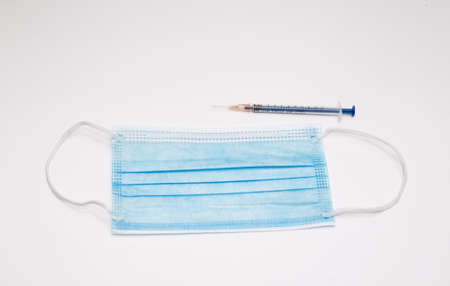 Medical mask and syringe on white background. Coronavirus conceptの写真素材