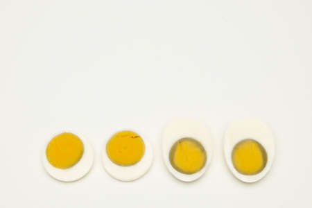 Four halves of boiled egg on a white backgroundの写真素材