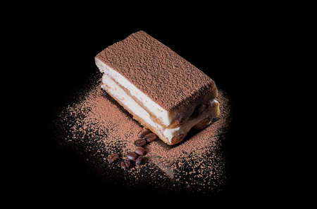 cakes with chocolate cream, beautifully decorated with a flower, on a black backgroundの写真素材