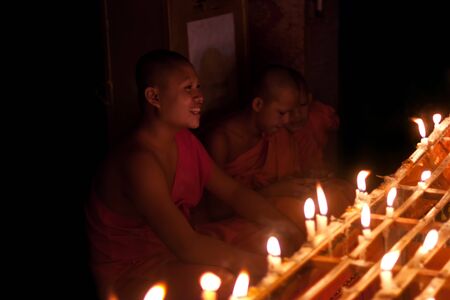 Luang Prabang, Laos - October 9: Unidentified monks light candles for the end of Buddhist Lent on...