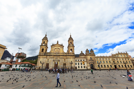 Bogota, Colombia - April 21: Unidentified tourists on a bike tour look at the Catedral Primada de Colombia and Capilla Del Sangrario chapel in the Plaza De Bolivar on April 21, 2016 in Bogota, Colombia.のeditorial素材